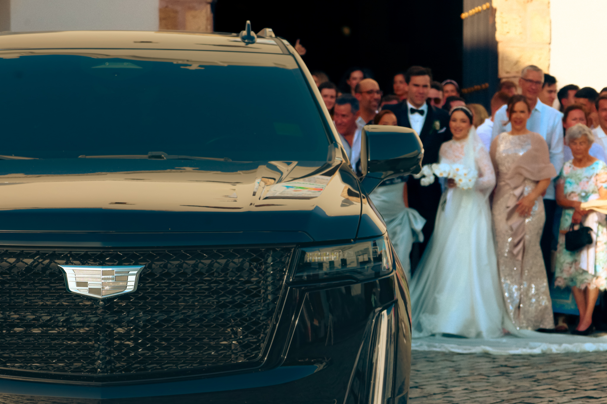 Bride and groom next to a black Luxplora SUV at a wedding in Puerto Rico